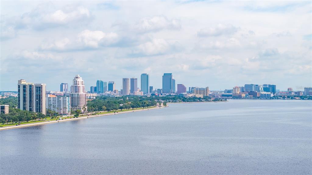 A wide-angle view of the Tampa skyline across the water under a cloudy blue sky — 3301 BAYSHORE BOULEVARD UNIT 1510A, TAMPA, FL