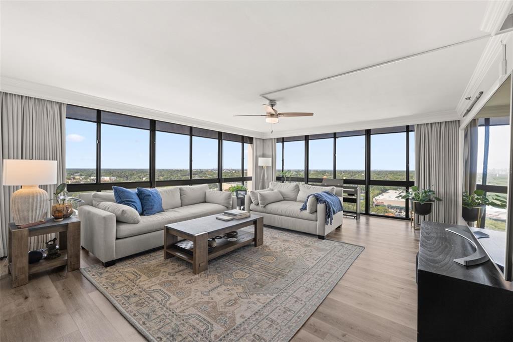 A living room with light wood floors, two sofas, a coffee table, and floor-to-ceiling windows — 3301 BAYSHORE BOULEVARD UNIT 1510A, TAMPA, FL