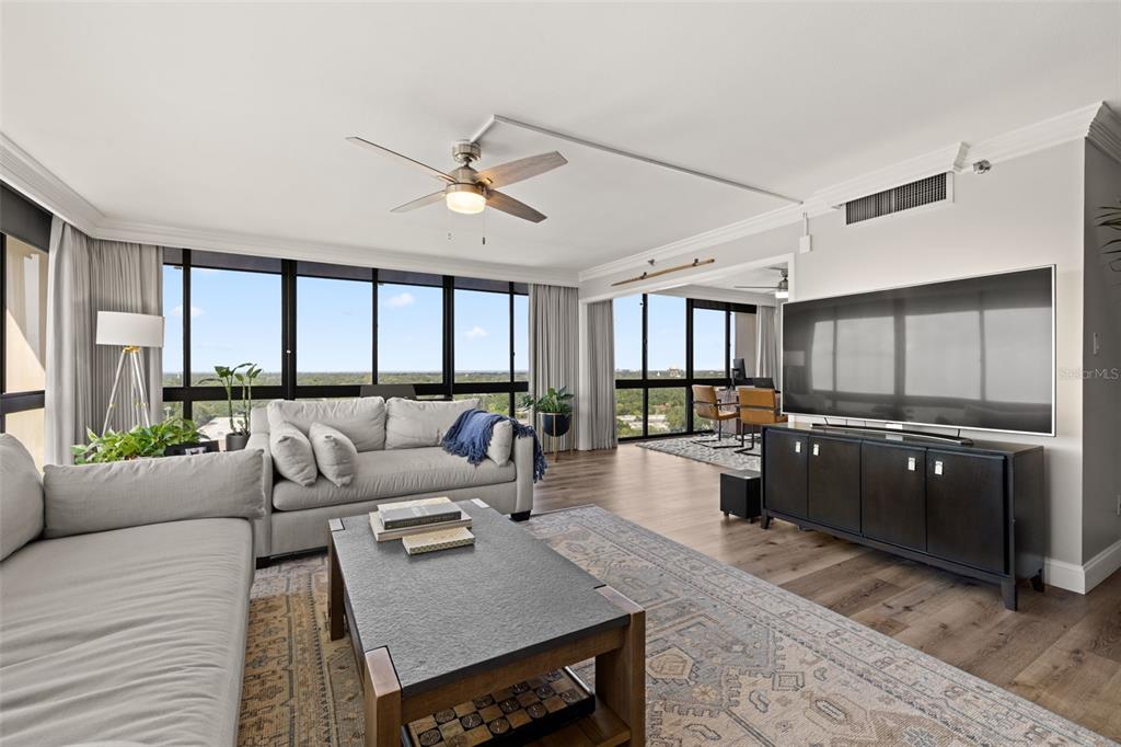 A living room features a grey sectional sofa, a coffee table, and large floor-to-ceiling windows — 3301 BAYSHORE BOULEVARD UNIT 1510A, TAMPA, FL