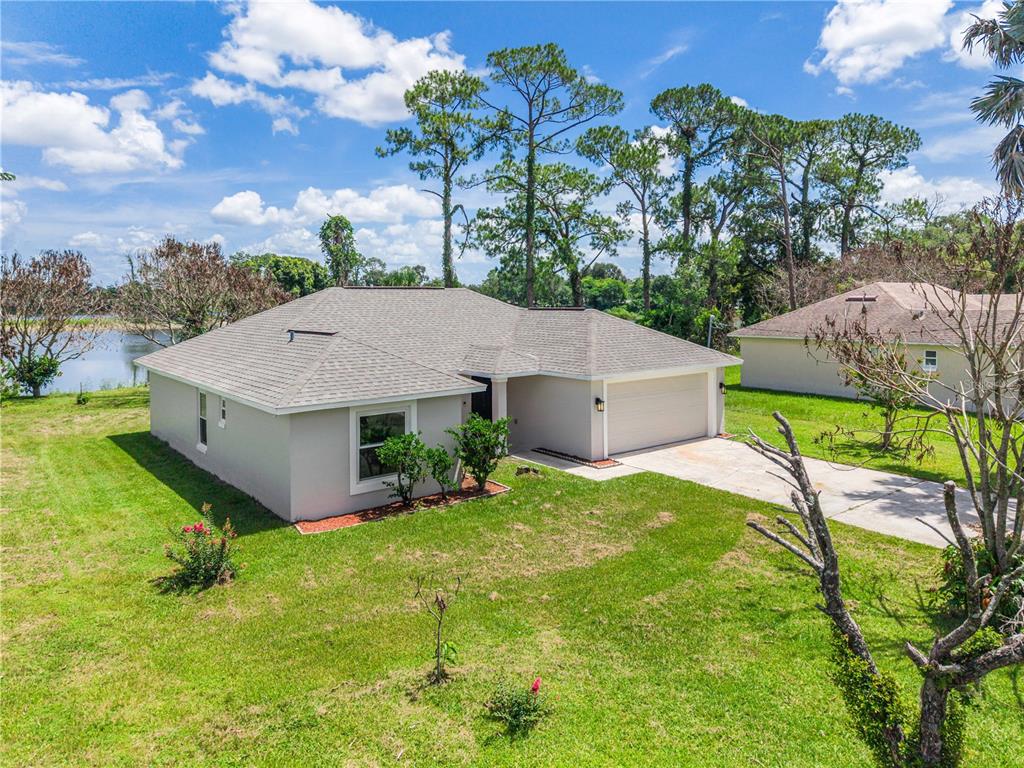 An aerial view of a single-story house with a two-car garage and a lake view — 201 RONNIE CIRCLE, ORLANDO, FL