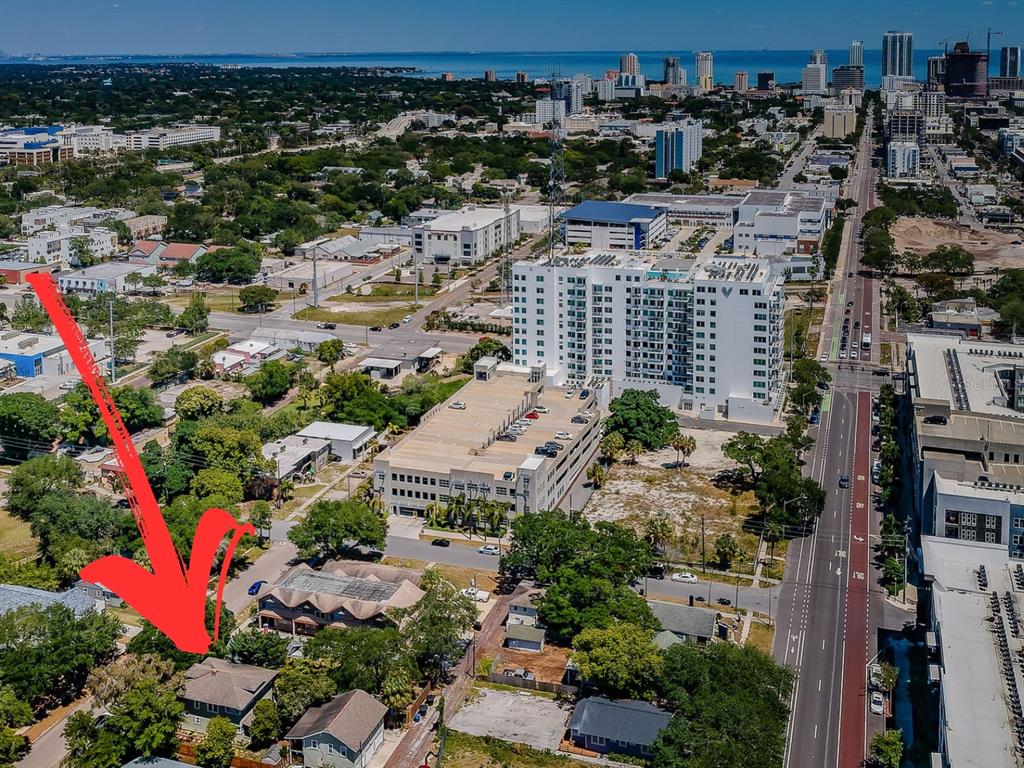 An aerial view of a residential house surrounded by trees near a city downtown area — 1720 2ND AVENUE N, ST PETERSBURG, FL