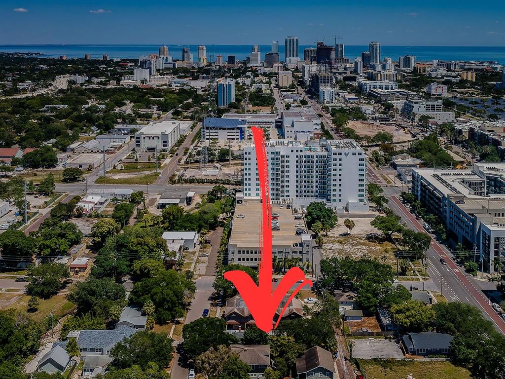 An aerial view shows a residential neighborhood with a red arrow pointing toward a house — 1720 2ND AVENUE N, ST PETERSBURG, FL