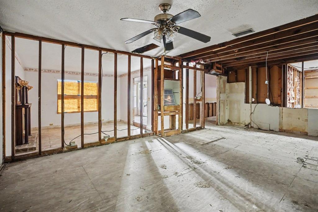 An interior view of a room under renovation with exposed wall studs and subflooring — 4921 DEESON ROAD, LAKELAND, FL