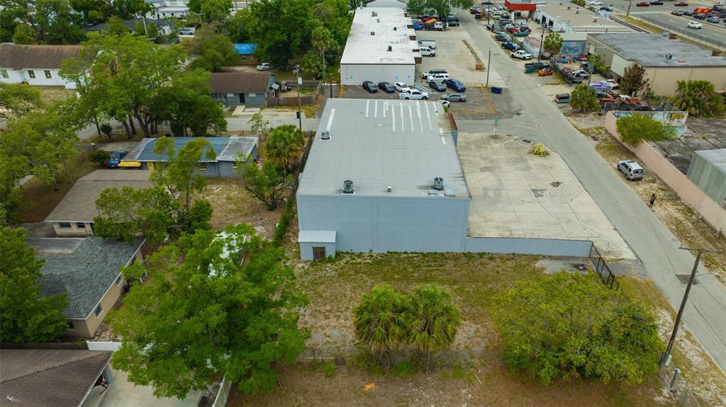 An aerial view shows a commercial building with a large adjacent lot and parking area — 1001 E SKAGWAY AVENUE, TAMPA, FL