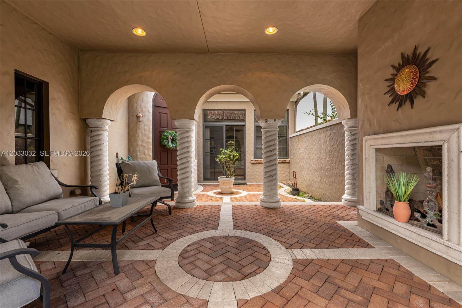 A backyard swimming pool with a brick paver deck surrounded by palm trees and landscaping — 9534 Ginger Ct, Parkland FL 33076, PARKLAND, FL