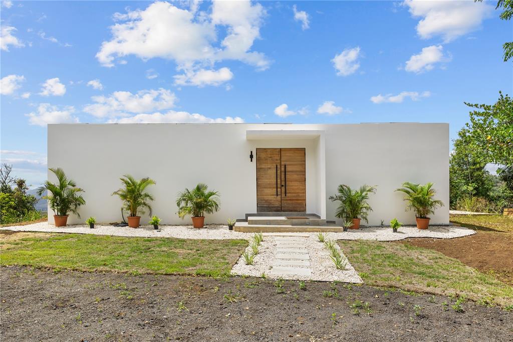 A modern living room with a large folding glass door opening to a mountain view — Bo Sumido 7737 KM 1 6, CAYEY, PR