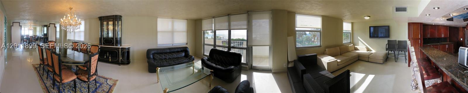 A panoramic view shows an open-concept living and dining area with tile flooring and ocean views — 1912 S Ocean Dr # 3D, Hallandale Beach FL 33009, HALLANDALE BEACH, FL