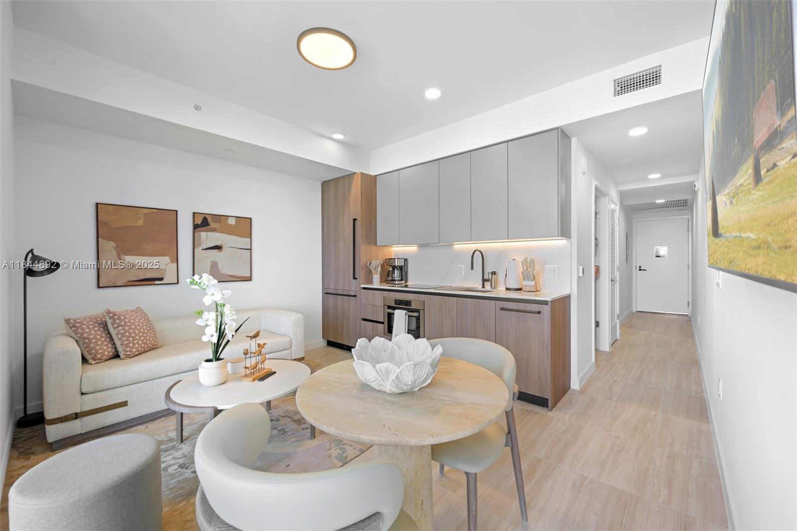 This studio apartment features a kitchenette, a small dining area, and a sofa — 580 72nd St # 1603, Miami Beach FL 33141, MIAMI BEACH, FL