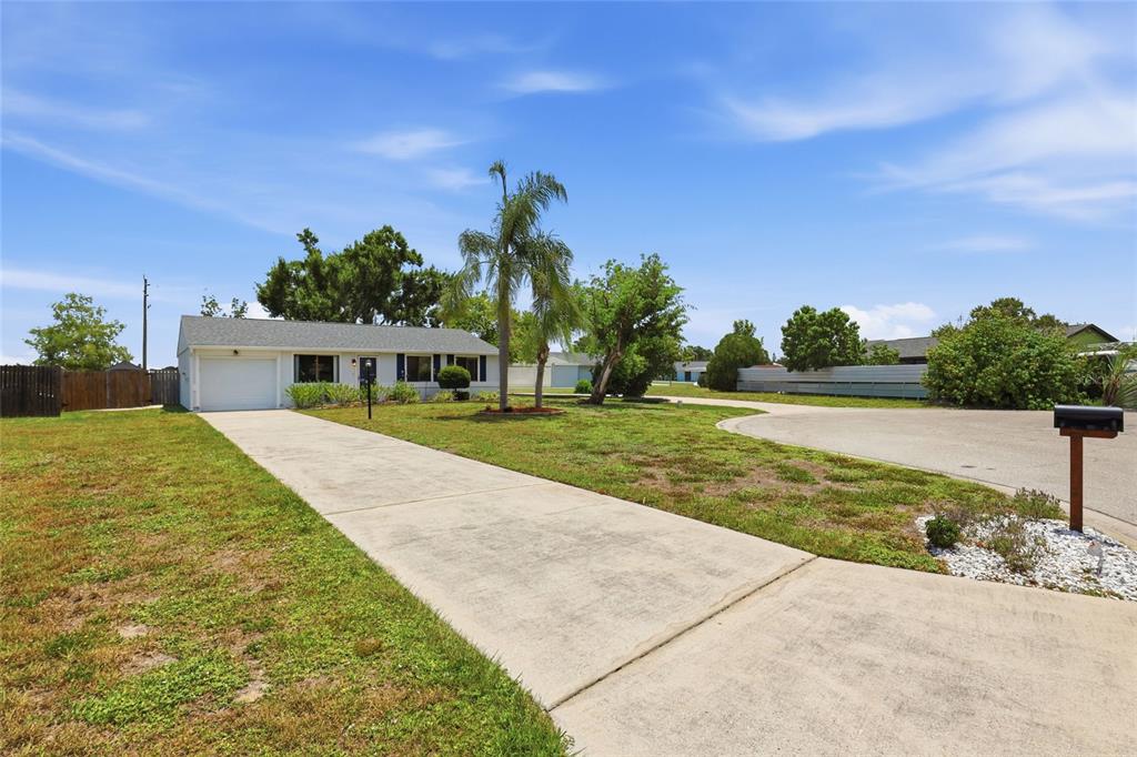 A single-story house with a white exterior, a garage, and a concrete driveway — 2959 N LOCKWOOD MEADOWS BOULEVARD, SARASOTA, FL