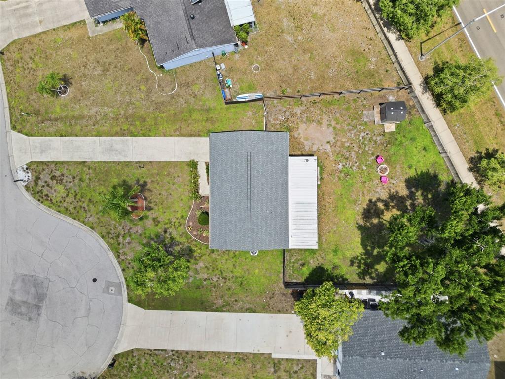 An aerial view shows a single-story house with a driveway and a large backyard — 2959 N LOCKWOOD MEADOWS BOULEVARD, SARASOTA, FL