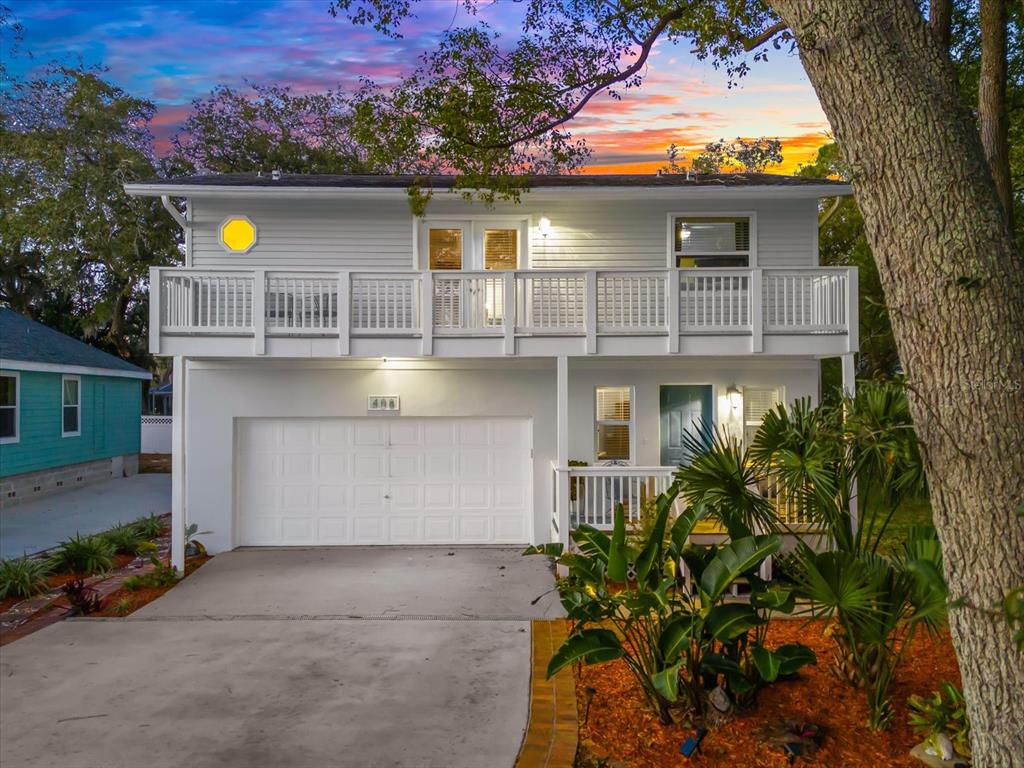 A two-story house with a white exterior, a garage, and an upper-level balcony — 408 GEORGIA AVENUE, CRYSTAL BEACH, FL