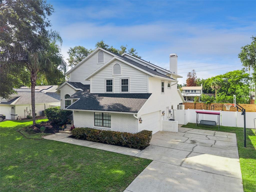An aerial view of a two-story white house with a driveway and a basketball hoop — 1458 ROYAL CIRCLE, APOPKA, FL