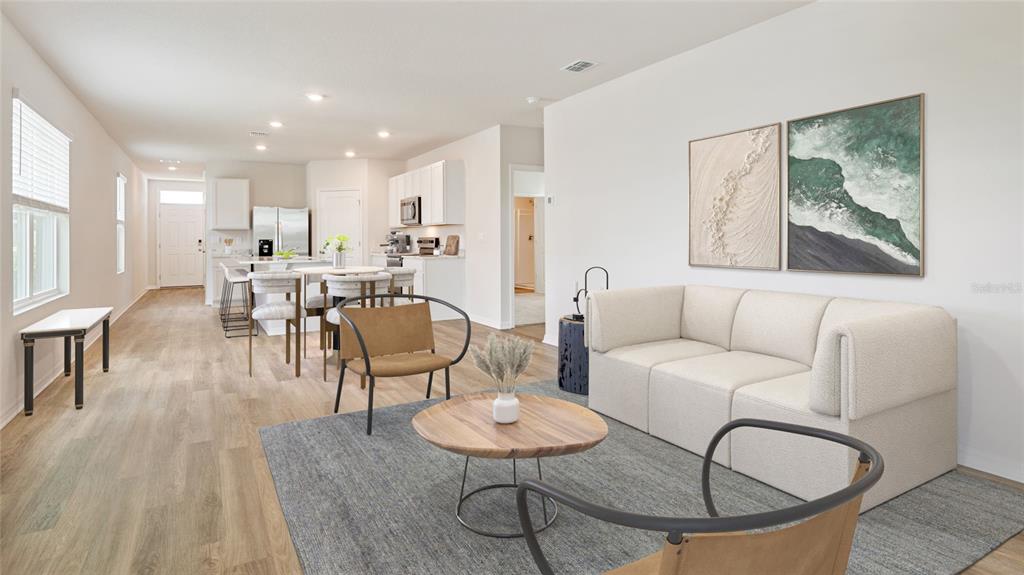 This is a digital rendering of an open-concept living room and kitchen with light flooring — 2459 25TH AVENUE S, ST PETERSBURG, FL