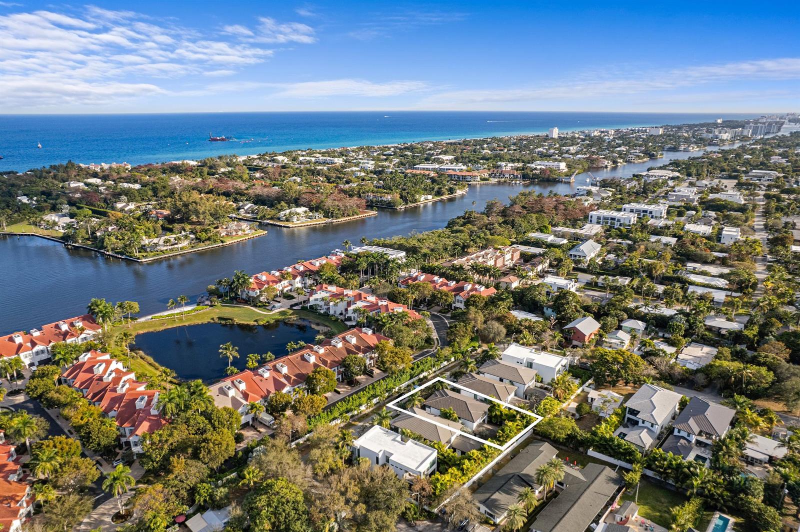 An aerial view shows a residential neighborhood with a highlighted house near a canal — 764 Lake Trail, Delray Beach FL 33483, DELRAY BEACH, FL