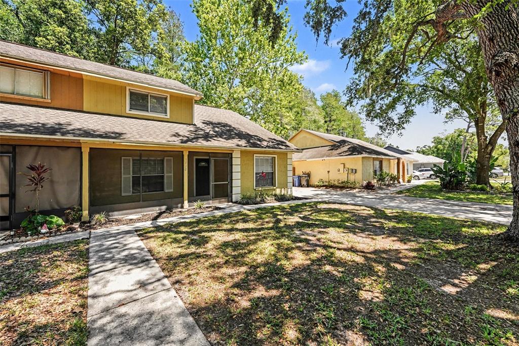 A two-story house with a screened-in porch and a concrete walkway in the front yard — 3408 LAUREL DALE DRIVE, TAMPA, FL