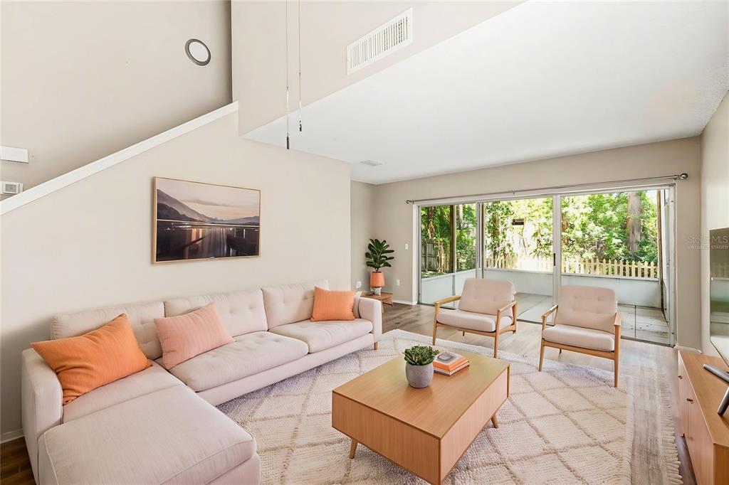 A living room features a sectional sofa, two armchairs, a coffee table, and sliding glass doors — 3408 LAUREL DALE DRIVE, TAMPA, FL