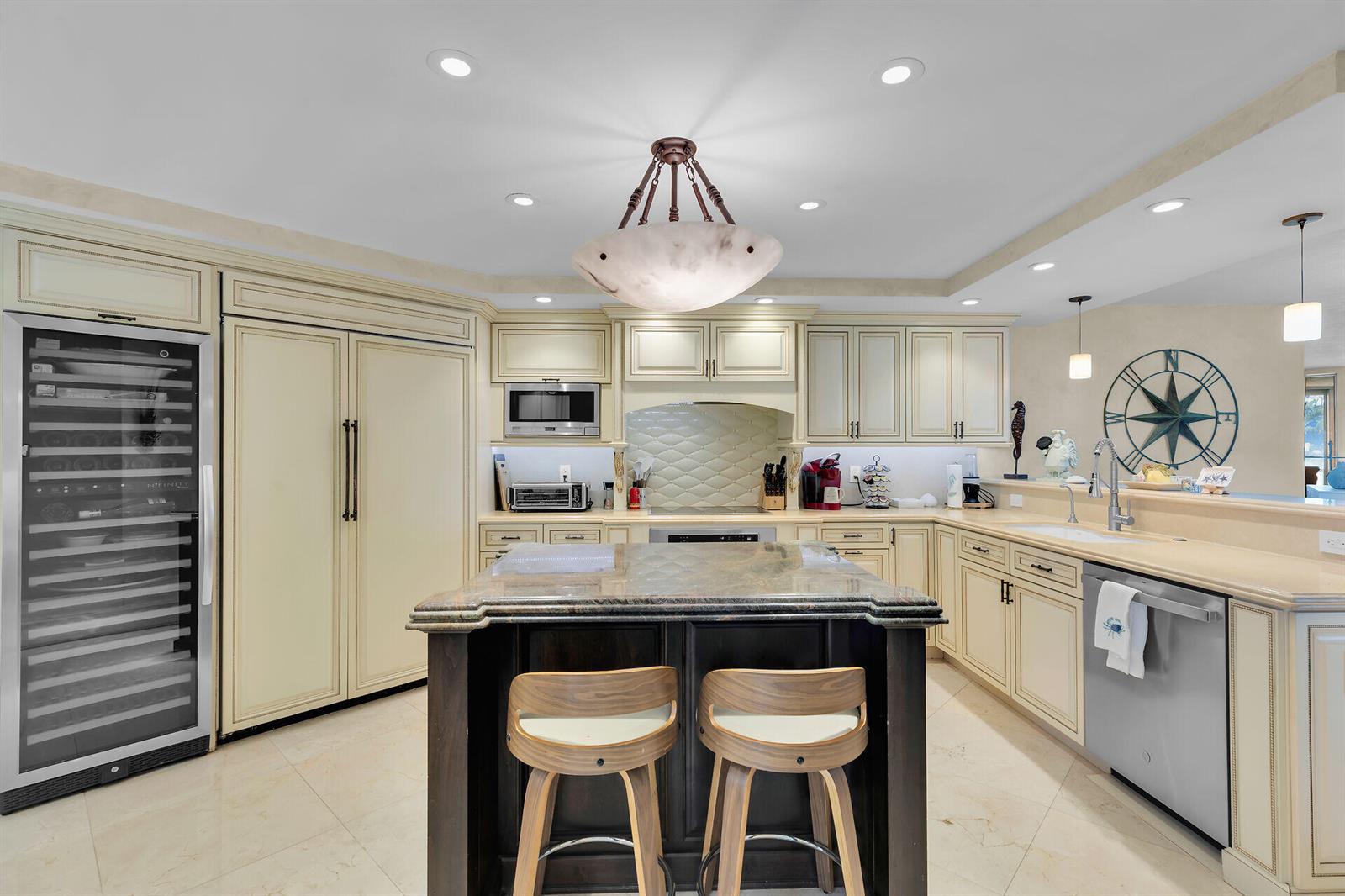 A kitchen with cream cabinets, a dark wood island, granite countertops, and stainless steel appliances — 87851 Old Highway # M5, Islamorada FL 33036, ISLAMORADA, FL