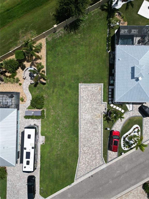 An aerial view shows two houses with paved driveways, a large lawn, and a parked RV — 8640 SW SAND CRANE CIRCLE LOT 48, ARCADIA, FL