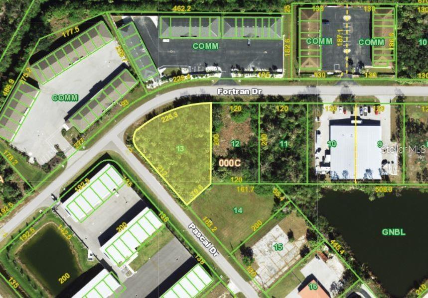 This is an aerial map showing several commercial lots and vacant land parcels near a road — 25421 FORTRAN DRIVE, PUNTA GORDA, FL