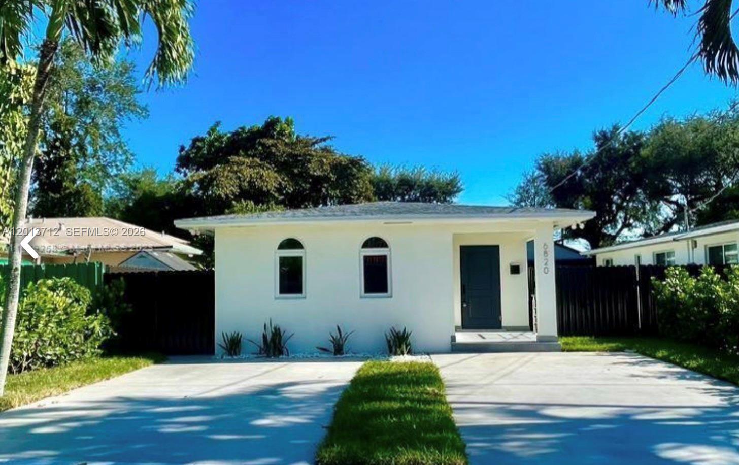 A single-story white house with two arched windows and a dark front door — 6820 SW 13th Ter # 6820, Miami FL 33144, MIAMI, FL