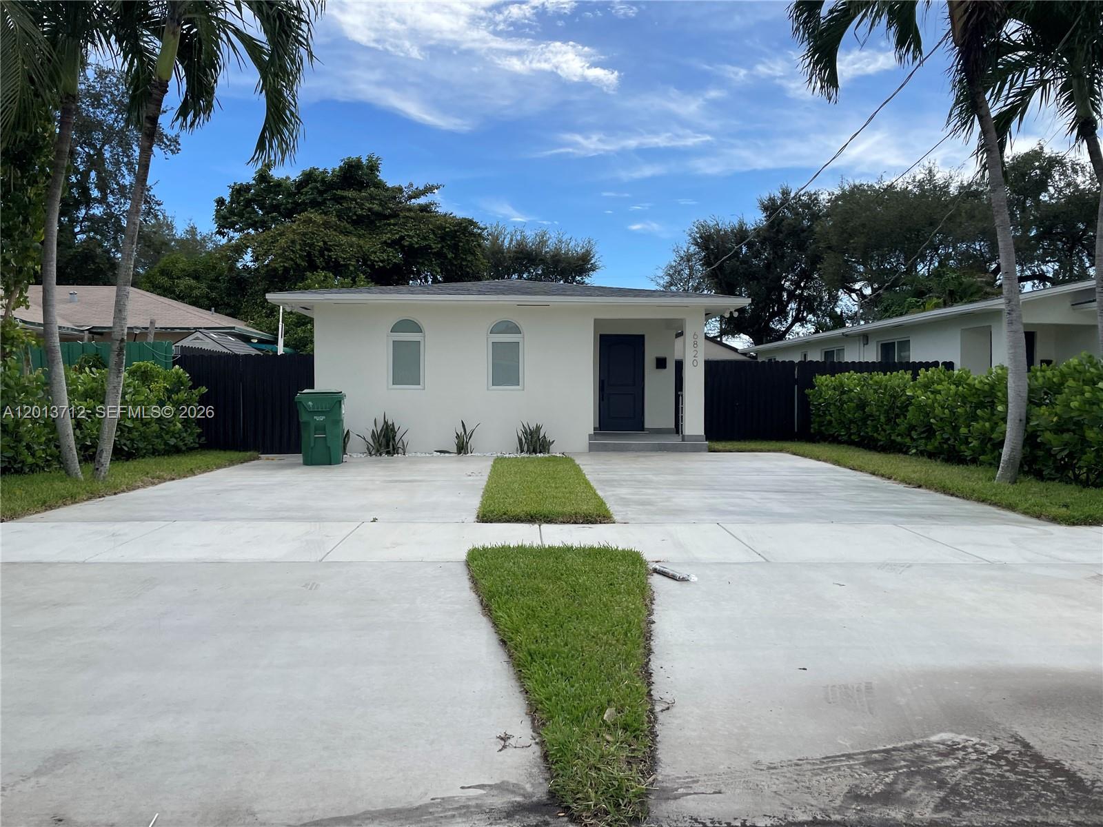 A single-story white house features a concrete driveway with a central grass strip — 6820 SW 13th Ter # 6820, Miami FL 33144, MIAMI, FL
