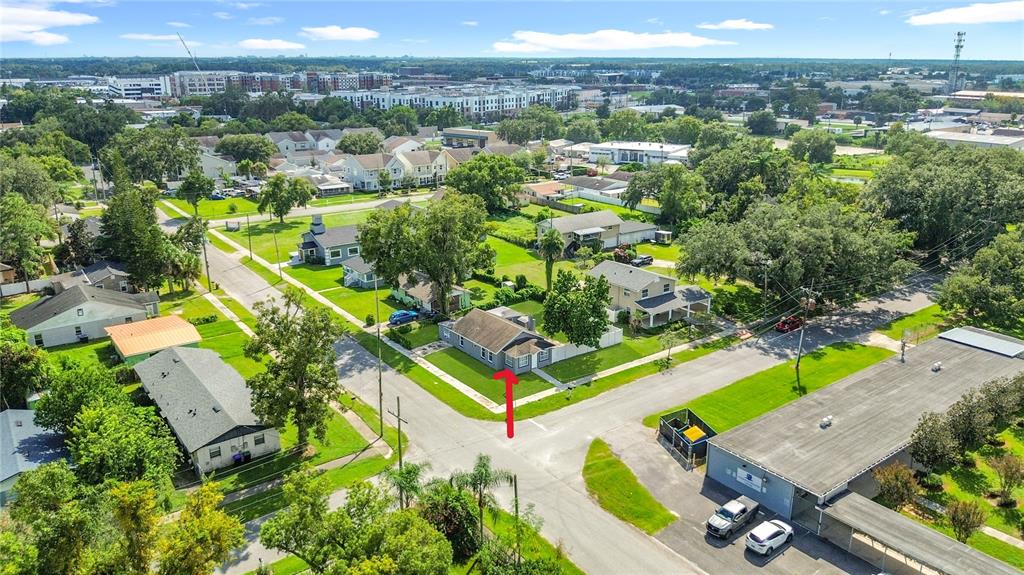 An aerial view shows a residential neighborhood with a red arrow pointing to a house — 1600 ROOSEVELT AVENUE, ORLANDO, FL
