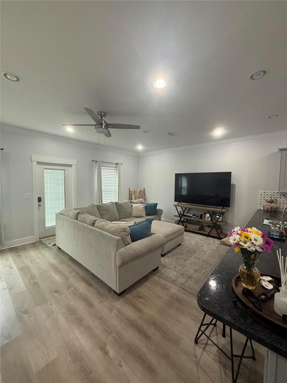 A living room features a sectional sofa, a television on a stand, and light flooring — 105 PENTECOST WAY, FORT WALTON BEACH, FL