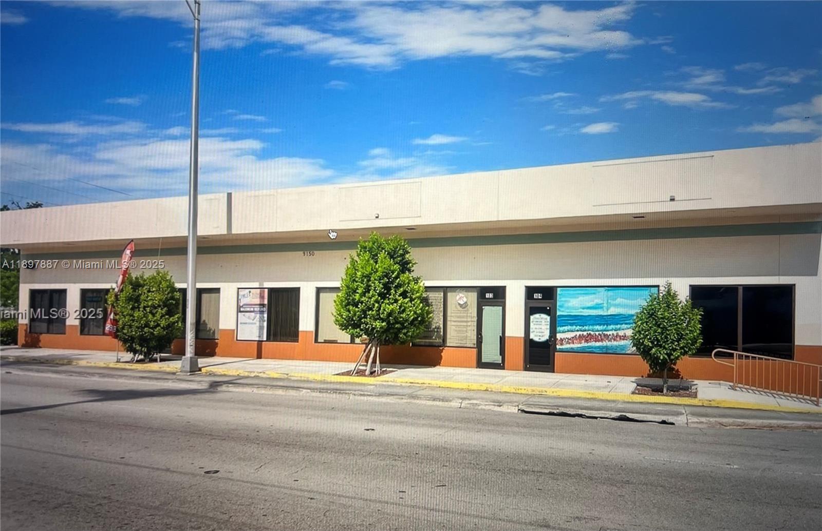 A single-story commercial building with a tan and orange facade and three small trees — 9150 NW 22nd Ave, Miami FL 33147, MIAMI, FL