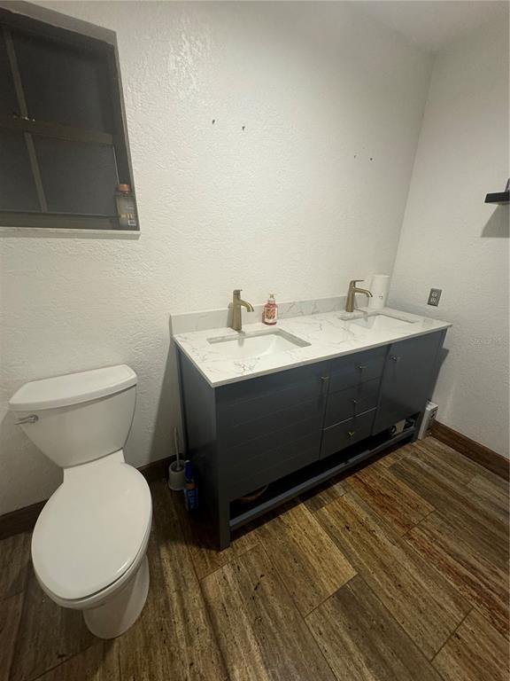 A bathroom features a double-sink vanity with a white marble countertop and dark gray cabinets — 2700 SE 157TH LANE ROAD, SUMMERFIELD, FL