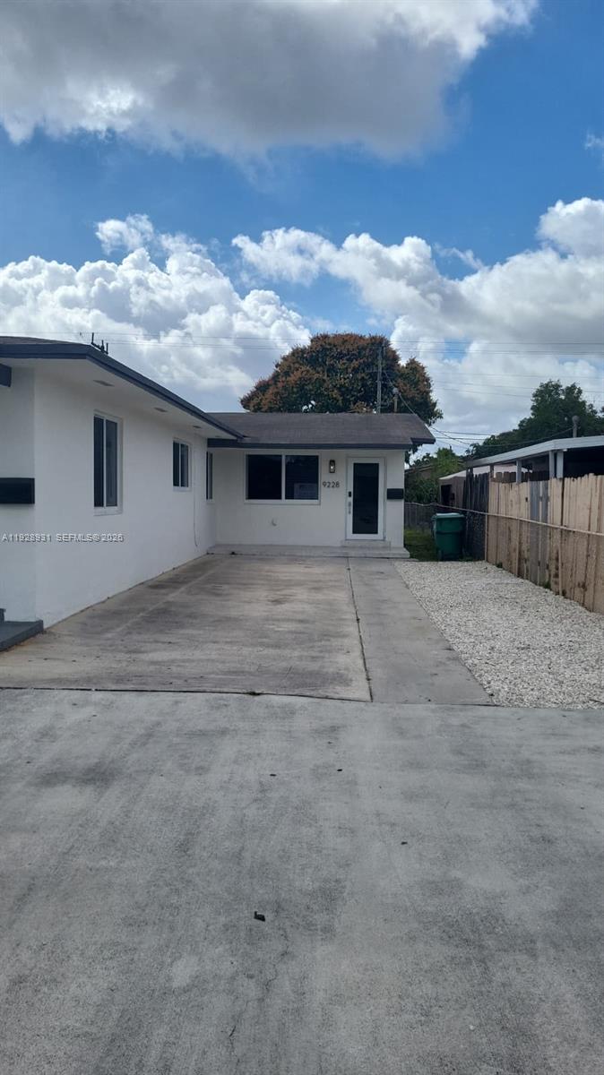 A white single-story house features a concrete driveway and a gravel side yard — 9228 SW 37th St # 9228, Miami FL 33165, MIAMI, FL