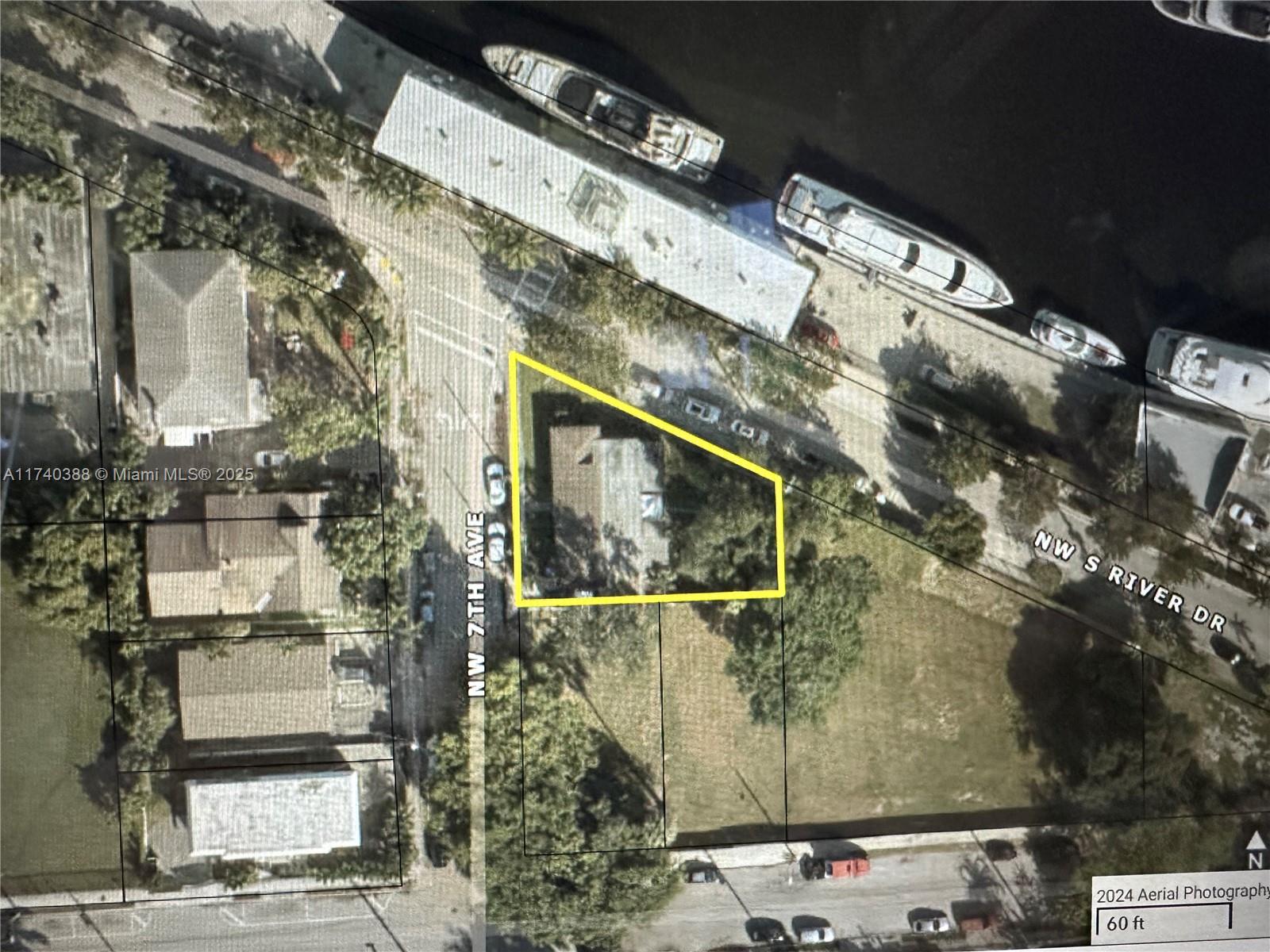 This aerial view shows a house on a corner lot near a river — 325 NW 7th Ave, Miami FL 33128, MIAMI, FL
