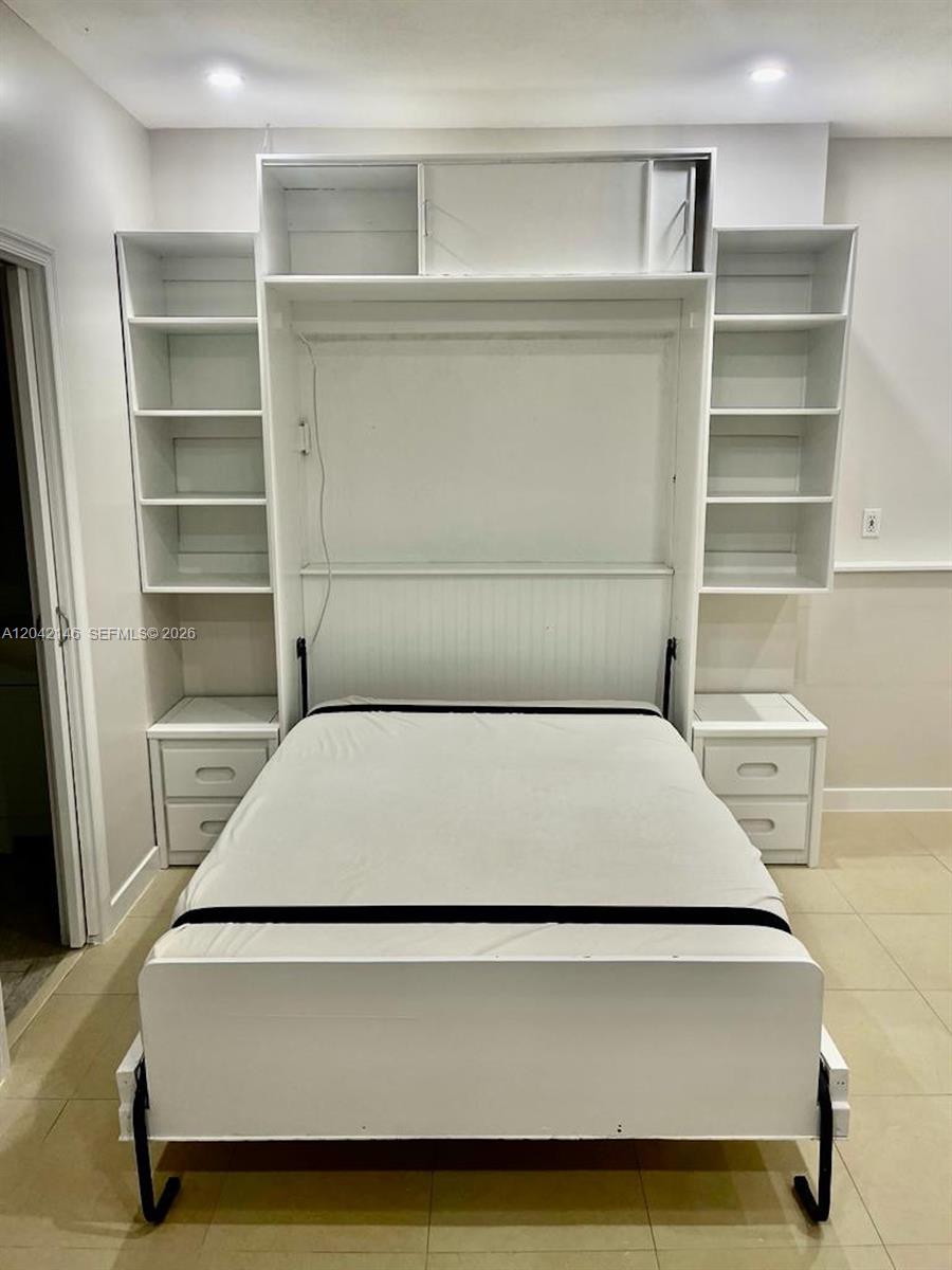 A white Murphy bed with integrated shelving and side cabinets is centered in the room — 14234 SW 163rd Ter # 2, Miami FL 33177, MIAMI, FL