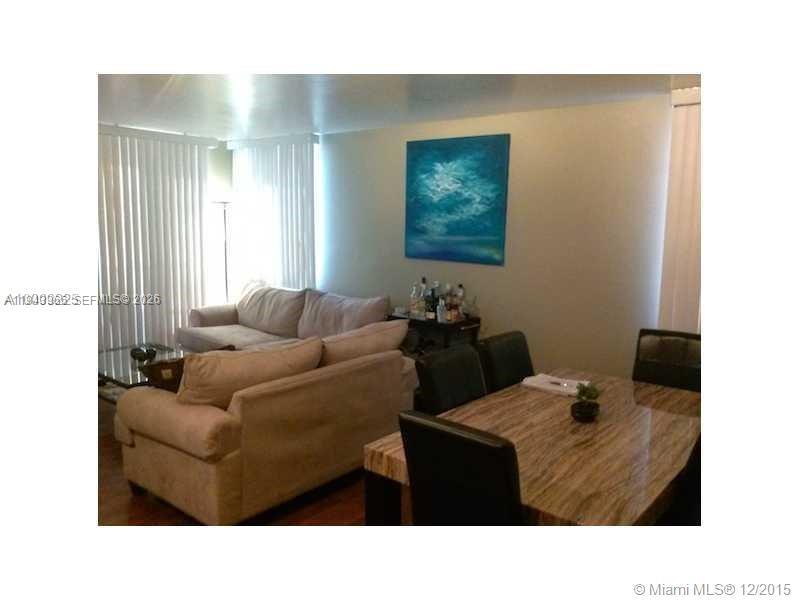 A living and dining room area features a beige sofa, dining table, and wall art — 800 N Miami Ave # 1108, Miami FL 33136, MIAMI, FL