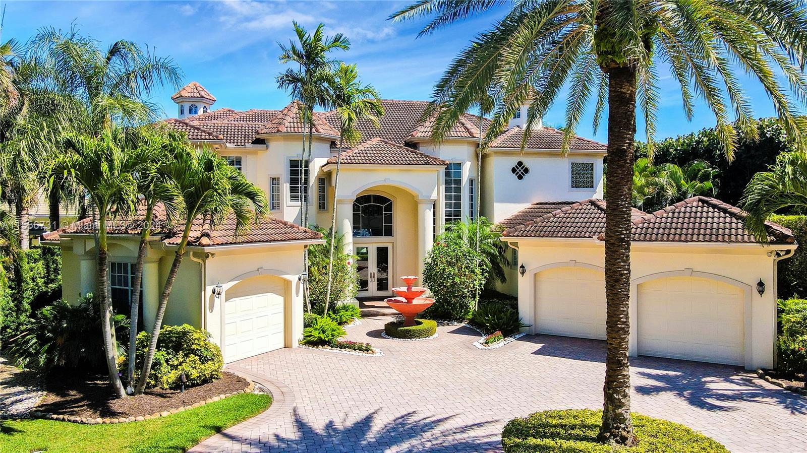 A two-story Mediterranean-style house features a paved driveway, a central fountain, and three garage bays — 17581 SE Conch Bar Ave, Jupiter FL 33469, JUPITER, FL