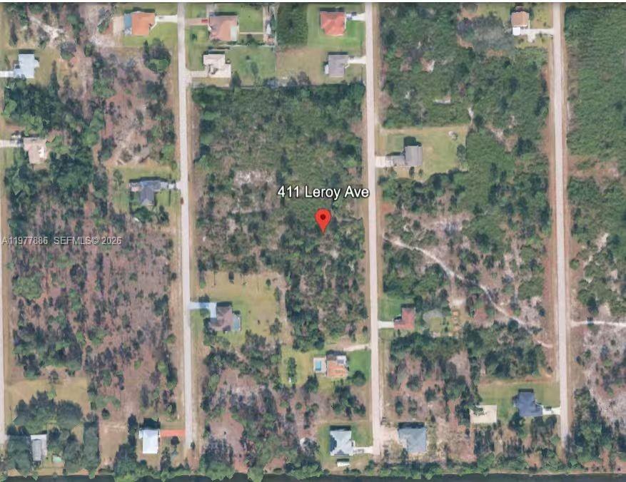This aerial map shows a vacant, wooded residential lot situated between two paved roads — 411 LEROY AVE, Lehigh Acres FL 33972, LEHIGH ACRES, FL