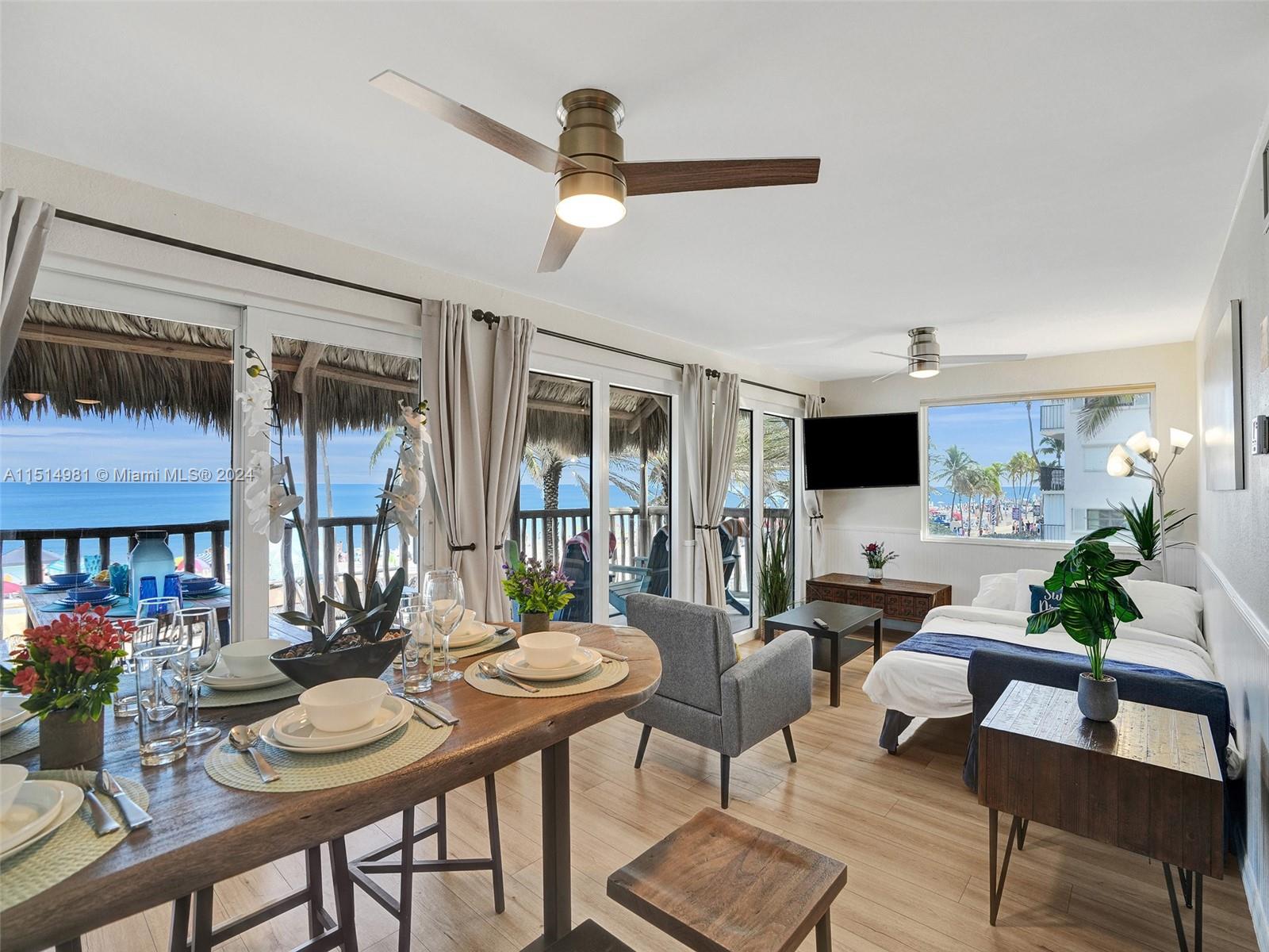 A studio apartment features a dining area, living space, and balcony overlooking the ocean — 900 N Surf Rd # 2, Hollywood FL 33019, HOLLYWOOD, FL