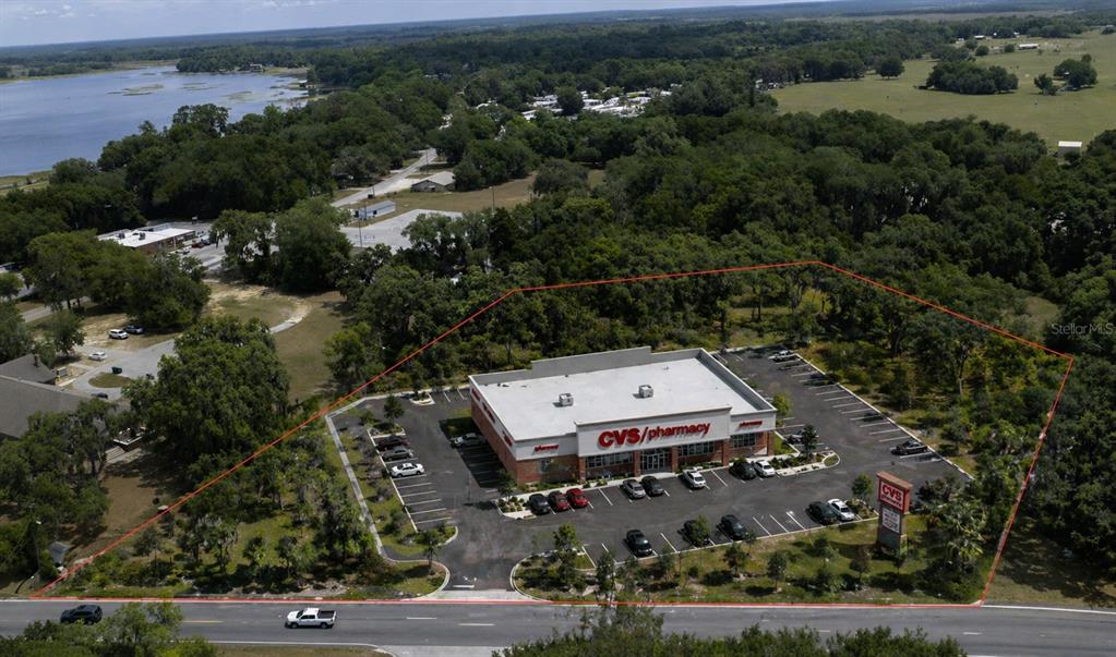 An aerial view shows a CVS pharmacy building surrounded by a parking lot and trees — 2355 N FLORIDA AVENUE, HERNANDO, FL