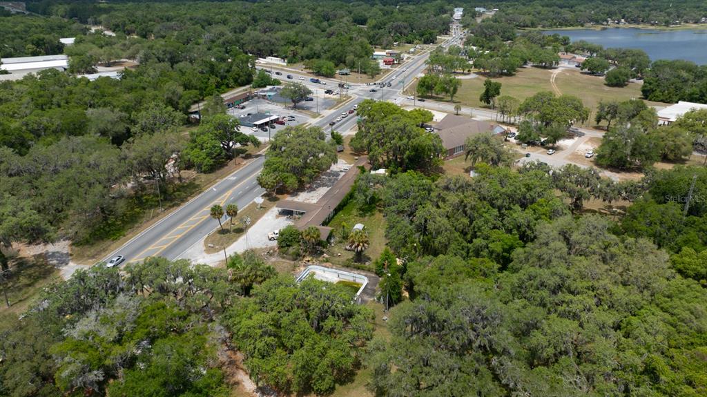 An aerial view shows a property with a house, pool, and surrounding trees near a road — 2355 N FLORIDA AVENUE, HERNANDO, FL
