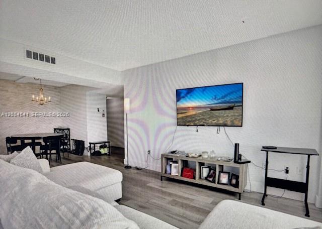 A living room features a wall-mounted television, a media console, and an adjacent dining area — 4174 Inverrary Dr # 914, Lauderhill FL 33319, LAUDERHILL, FL
