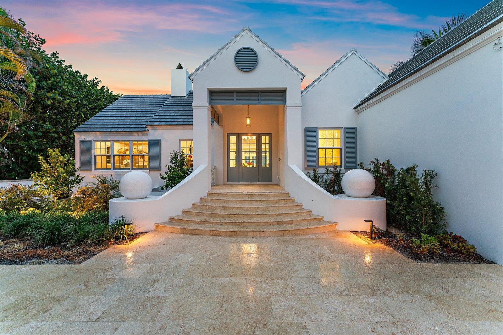 A white house with a stone staircase, large spherical accents, and a gray-shingled roof — 43 N Beach Road, Hobe Sound FL 33455, HOBE SOUND, FL