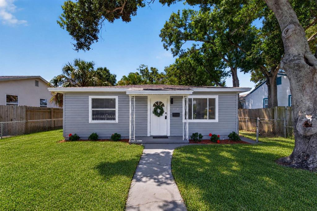 A single-story gray house with a white front door and a concrete walkway — 4110 3RD AVENUE S, ST PETERSBURG, FL