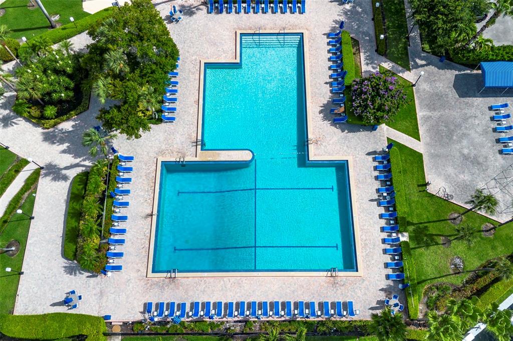 An aerial view shows a large, uniquely shaped swimming pool surrounded by lounge chairs — 500 THREE ISLANDS BOULEVARD UNIT 1008, HALLANDALE BEACH, FL