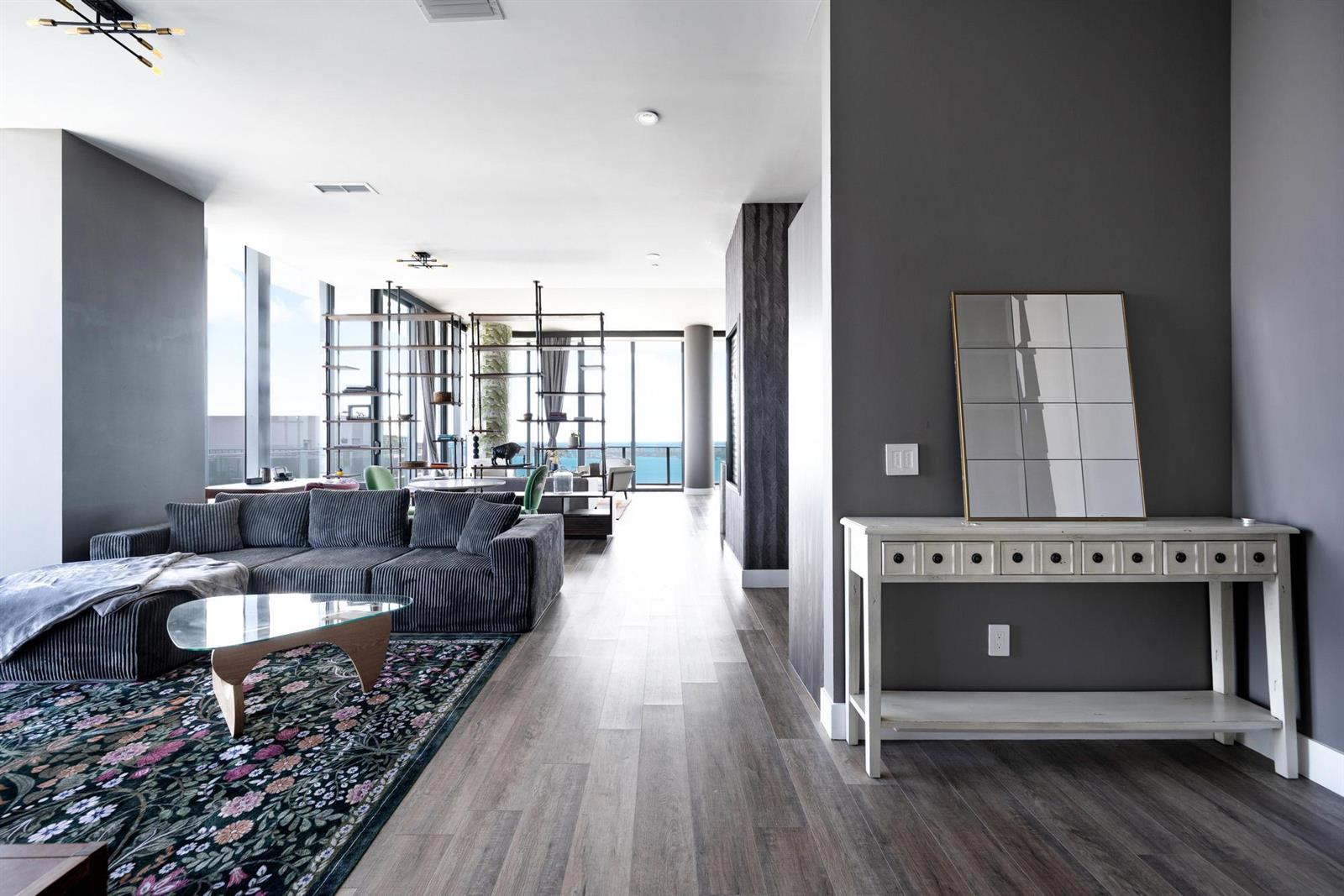 This rendering shows a modern bedroom with light wood floors, a bed, and an ensuite bathroom — 480 NE 31st Street, Miami FL 33137, MIAMI, FL