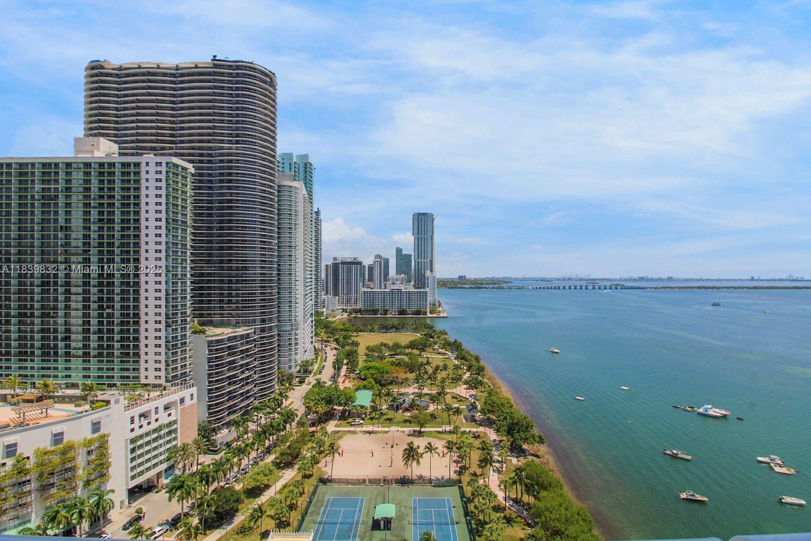 An elevated view of a waterfront park, tennis courts, and high-rise apartment buildings in Miami — 1717 N Bayshore Dr # 2635, Miami FL 33132, MIAMI, FL
