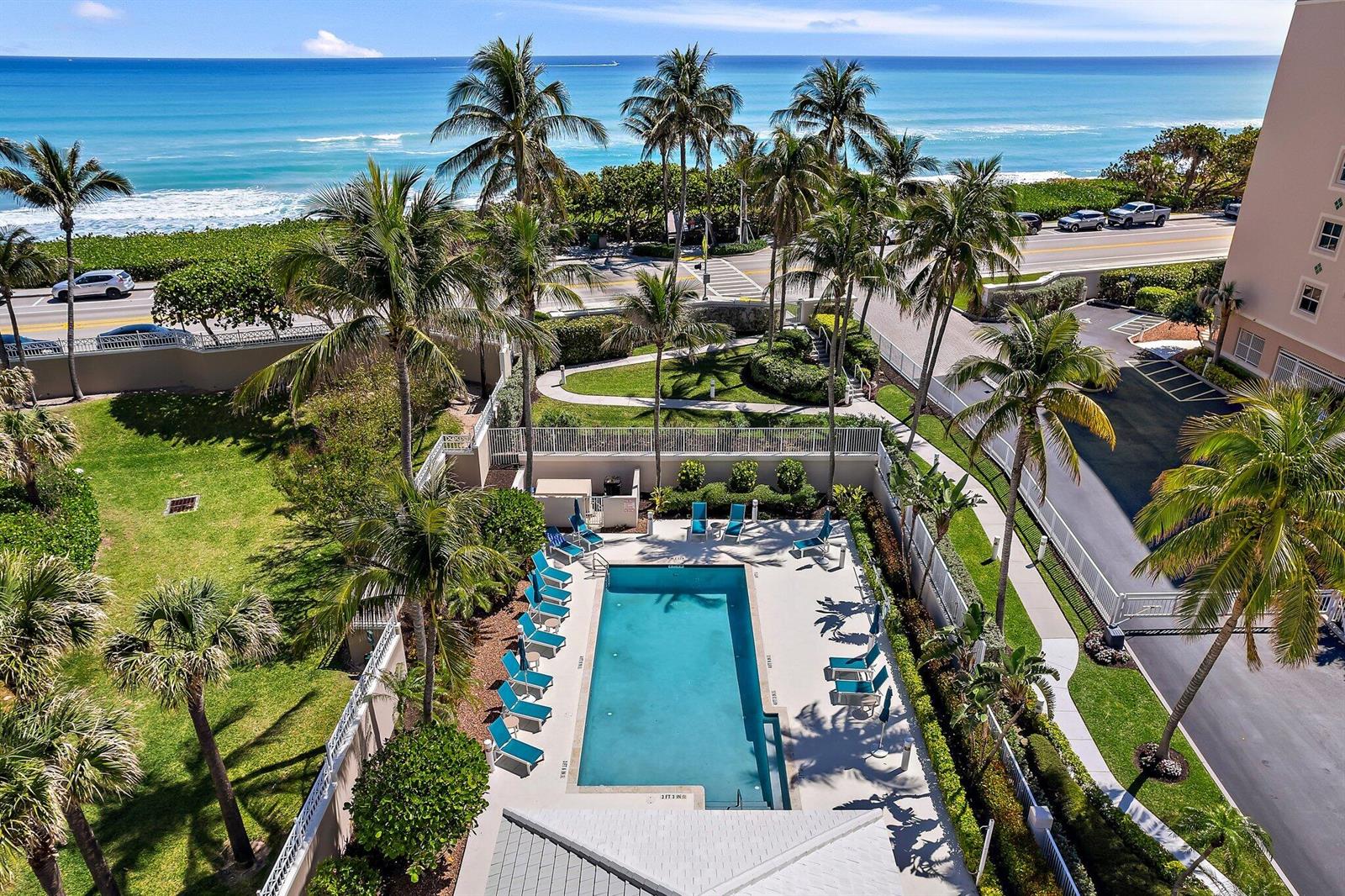 An aerial view of a rectangular swimming pool surrounded by lounge chairs and palm trees — 1660 S Hwy A1a # 122, Jupiter FL 33477, JUPITER, FL