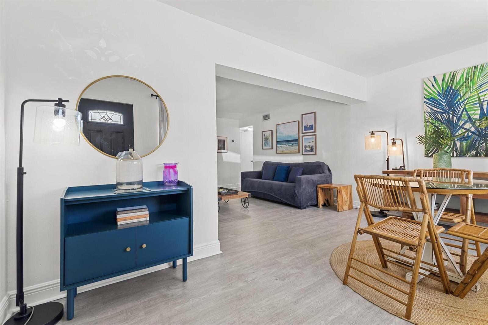 A bright living and dining area features white walls, light wood flooring, and blue furniture — 6375 SW 29th Street, Miami FL 33155, MIAMI, FL