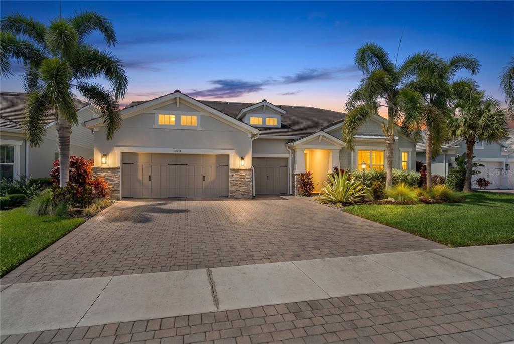 A living room with wood ceiling beams, a fireplace, and an open kitchen — 12215 PORTSMOUTH TERRACE, BRADENTON, FL