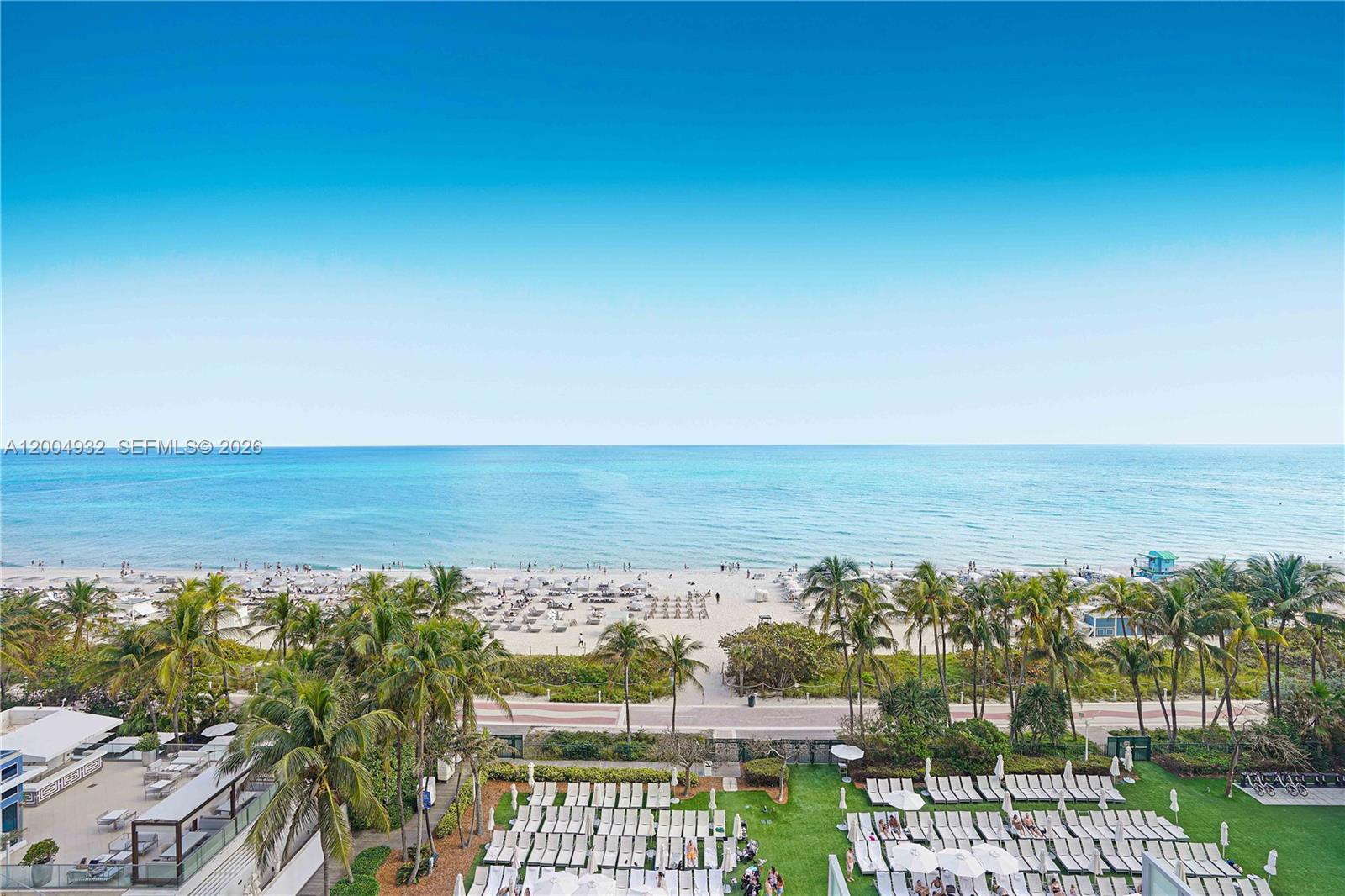 An elevated view shows a beach, ocean, and a pool deck with lounge chairs — 4391 Collins Ave # 709, Miami Beach FL 33140, MIAMI BEACH, FL
