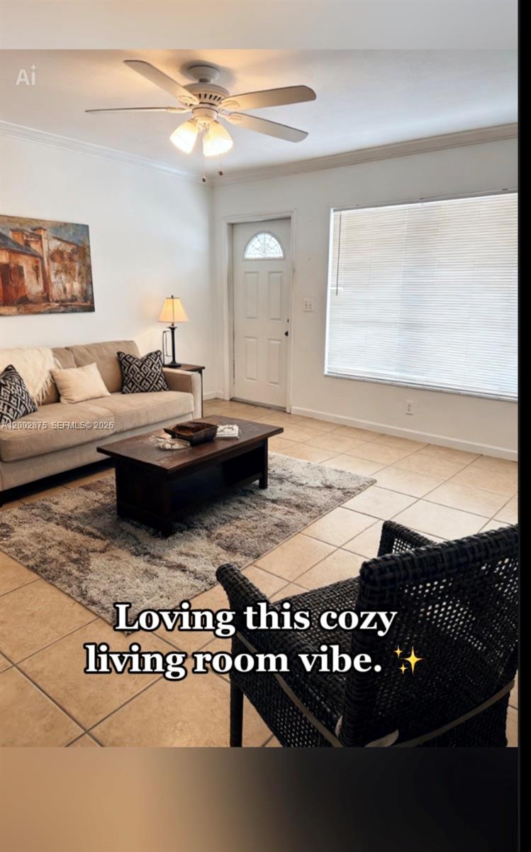A living room features a beige sofa, dark coffee table, tiled floors, and a ceiling fan — 412 SW 10th St # 2, Hallandale Beach FL 33009, HALLANDALE BEACH, FL