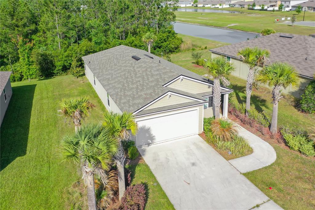 An aerial view of a single-story house with a two-car garage and palm trees — 6214 WILD MUSTANG TRAIL, JACKSONVILLE, FL